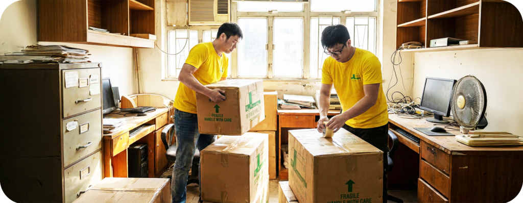 實惠搬屋師傅在裝修工地現場小心搬運已包裹保護膜的鋼琴，展示裝修期間的專業傢俬暫存服務。強調免受油漆沙塵損壞的極致保護，是裝修搬屋公司的信心之選。